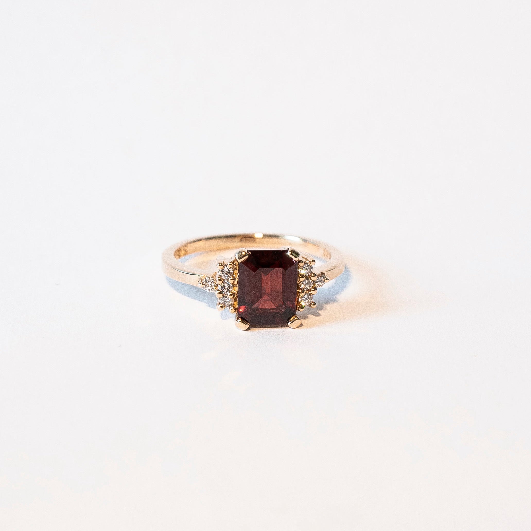 Emerald-cut garnet ring with eight diamonds