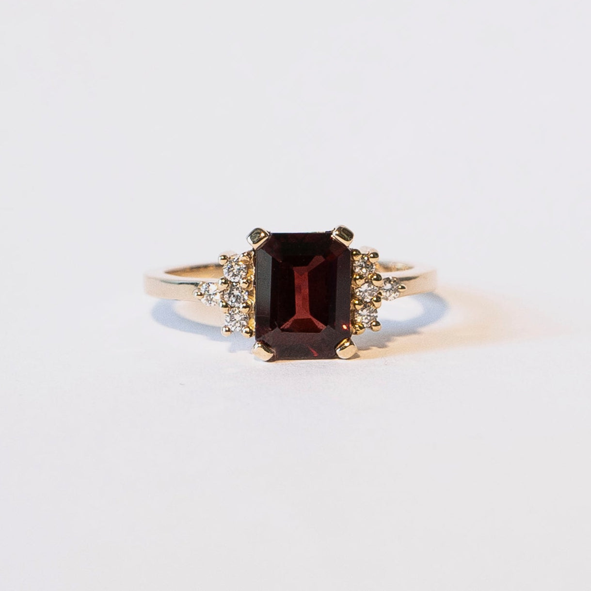 Emerald-cut garnet ring with eight diamonds