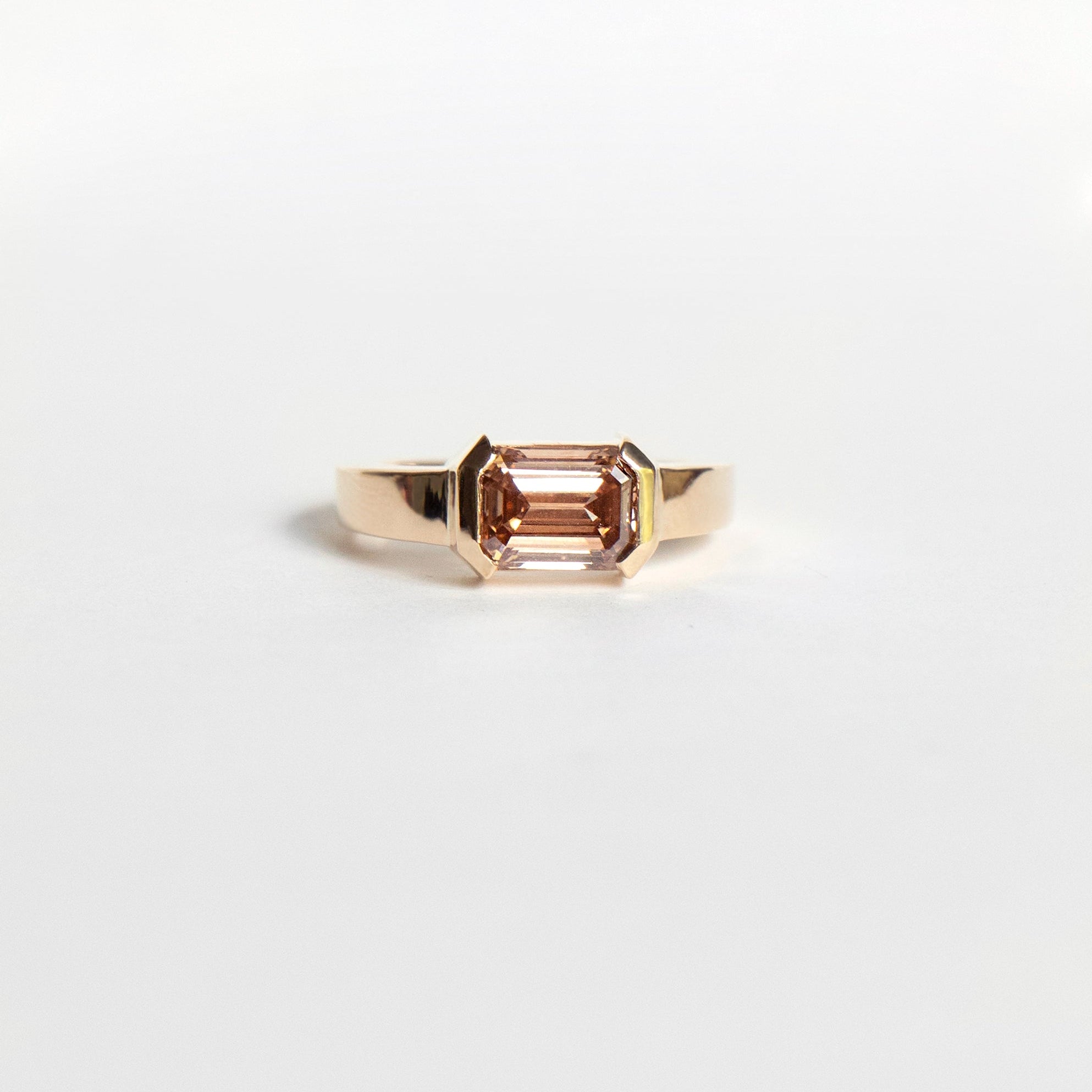 East-west emerald-cut fancy brown lab-grown diamond ring in half bezel