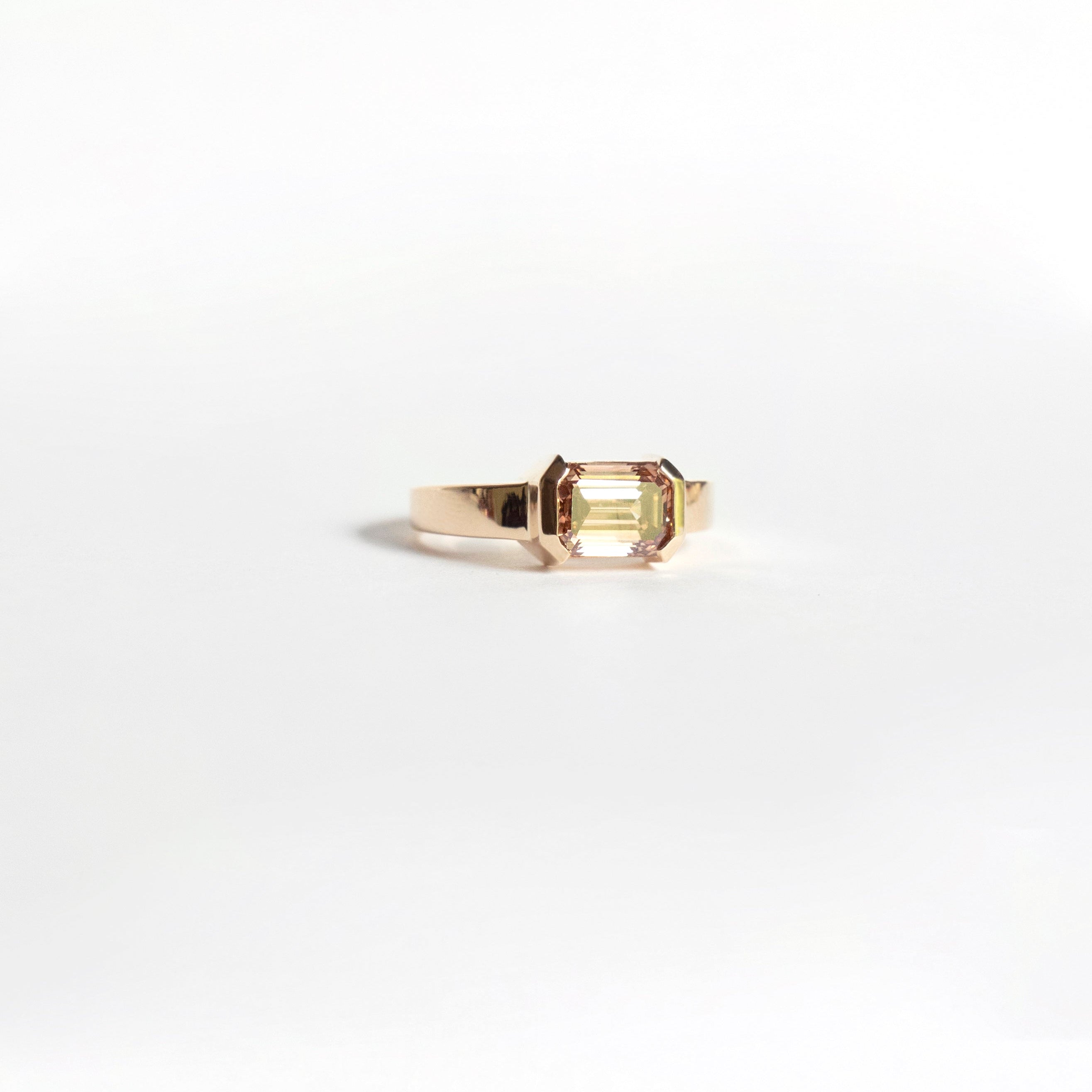 East-west emerald-cut fancy brown lab-grown diamond ring in half bezel