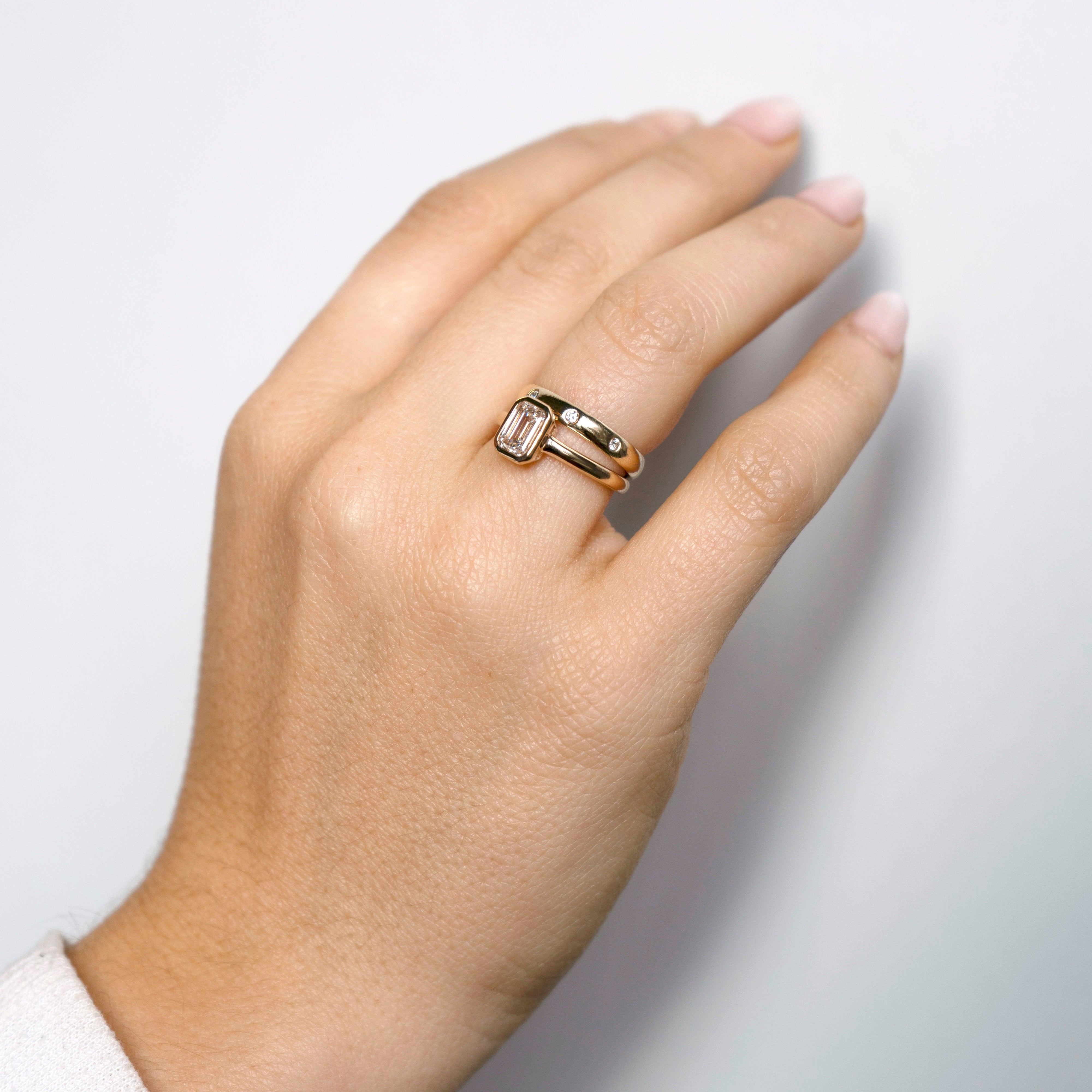 Emerald-cut lab-grown diamond engagement ring and diamond wedding band set