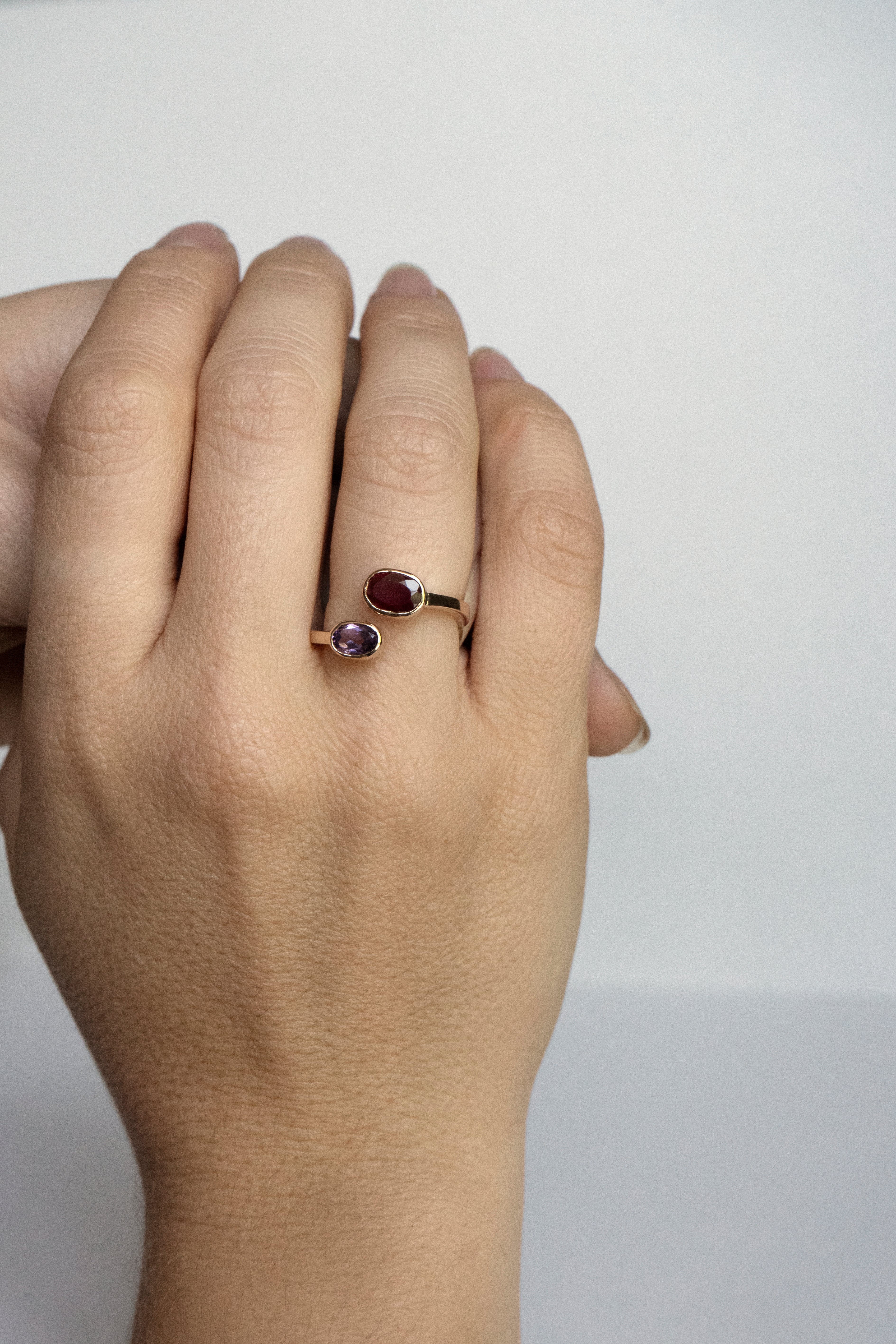 Oval ruby and amethyst bezel ring set east–west