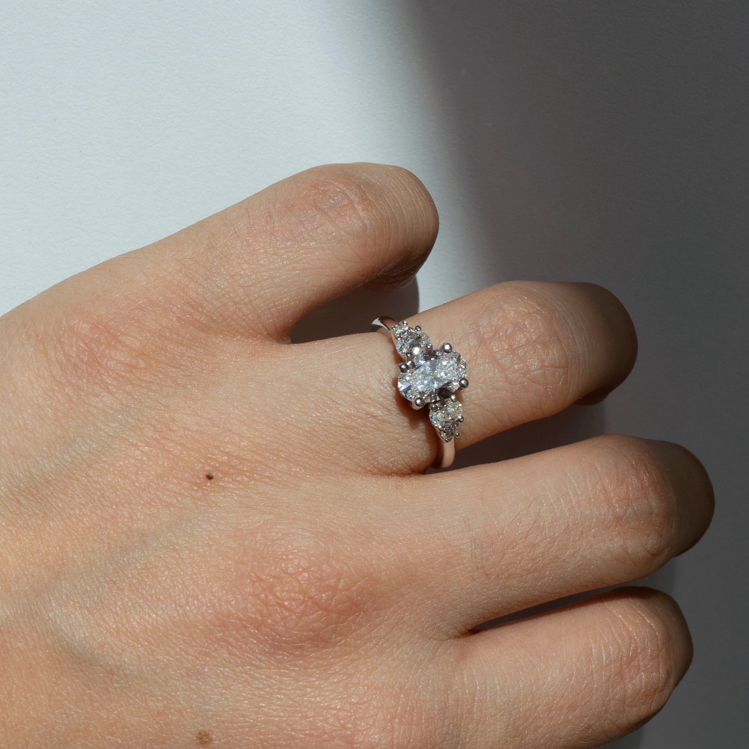 Oval diamond engagement ring with oval and round diamond accents