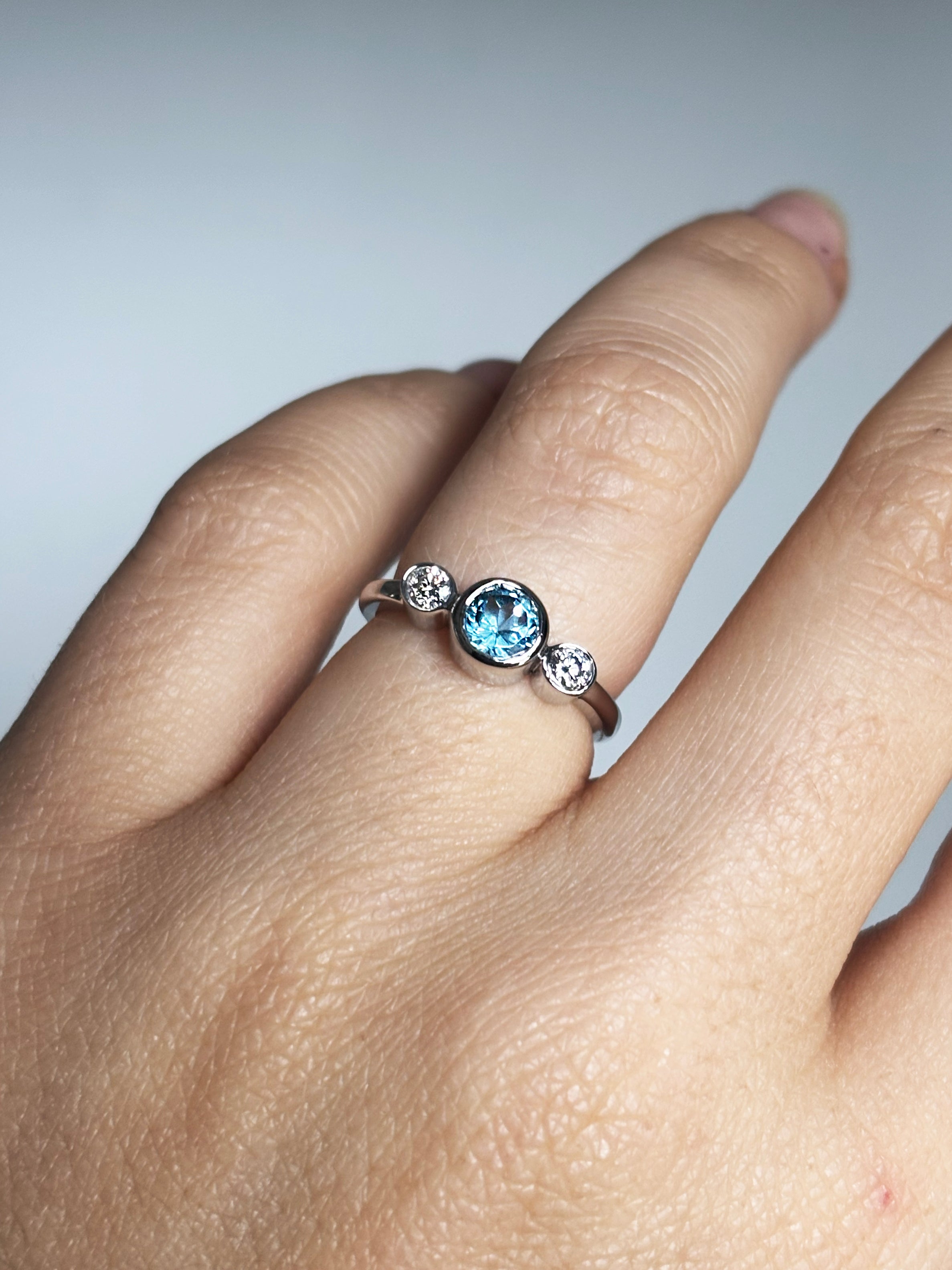 Round blue topaz and diamonds bezel ring