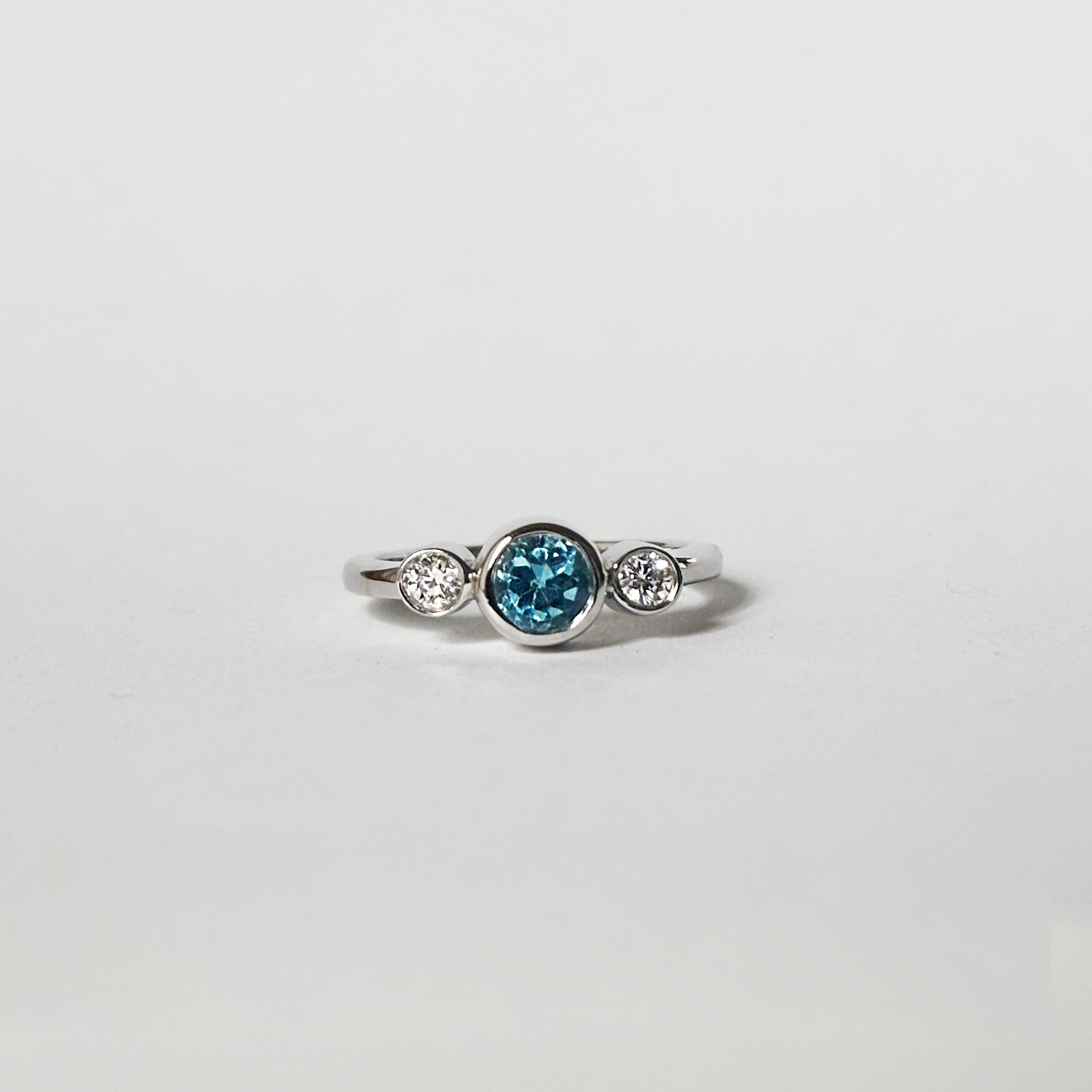 Round blue topaz and diamonds bezel ring