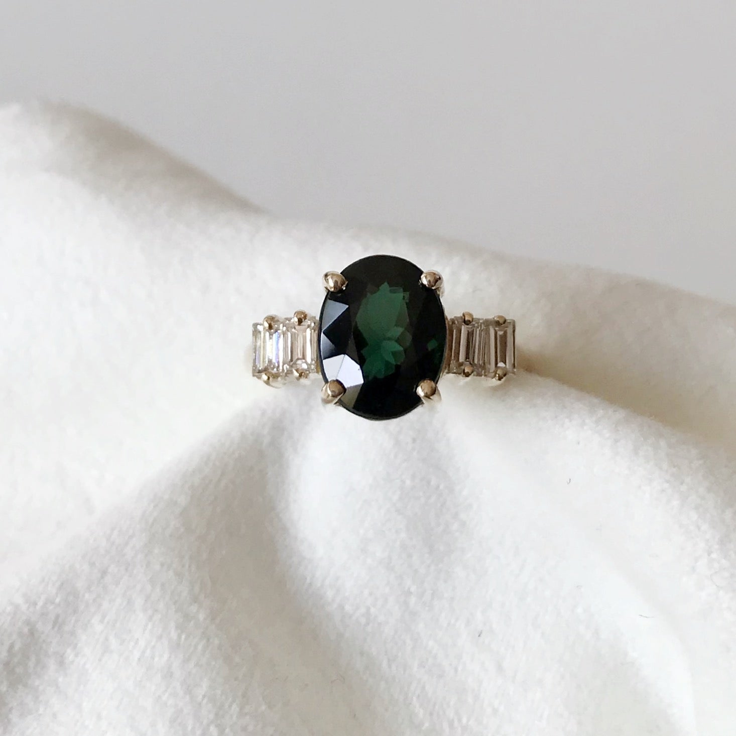 Oval green tourmaline and baguette diamonds engagement ring