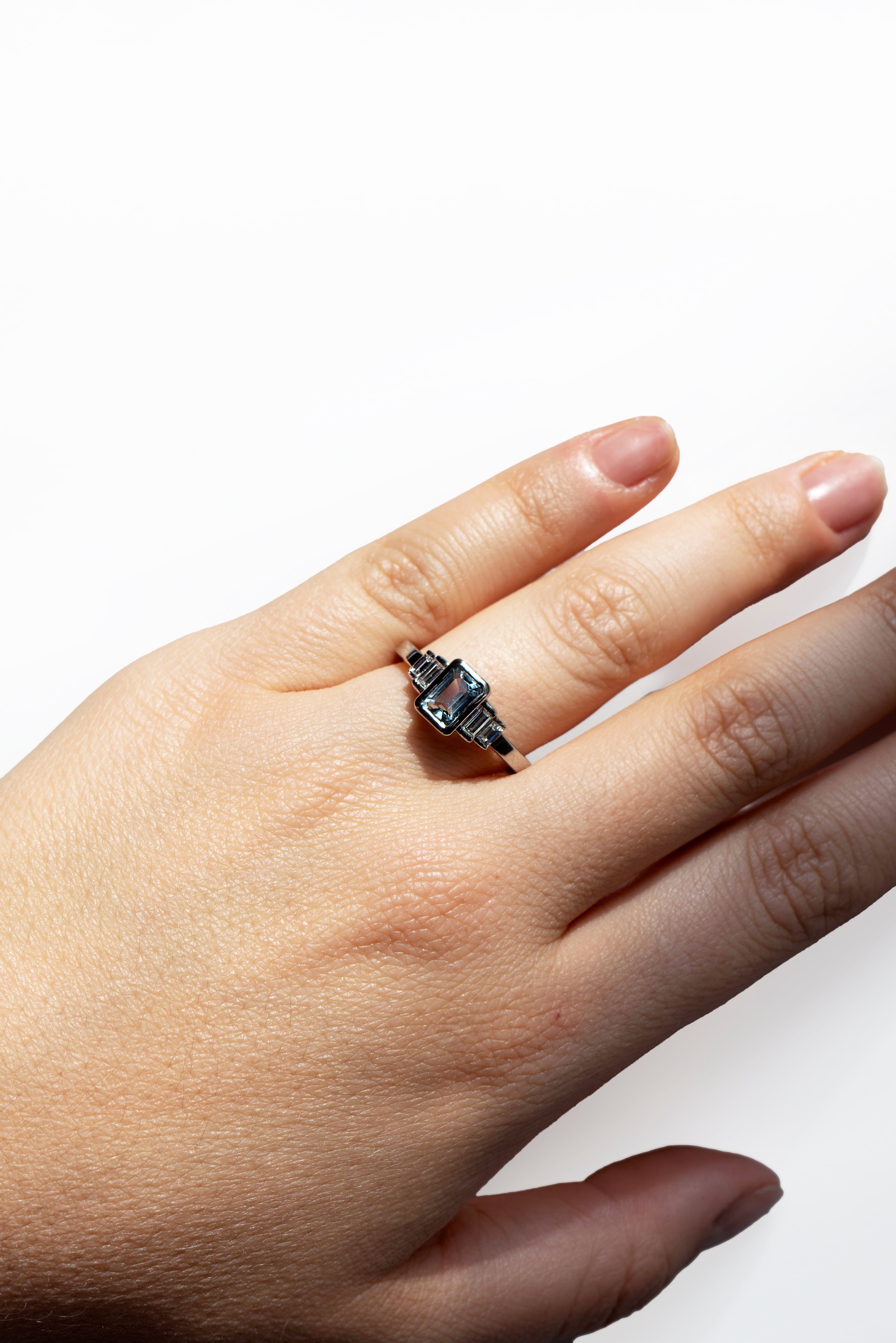 Emerald-cut aquamarine and baguette diamonds platinum engagement ring