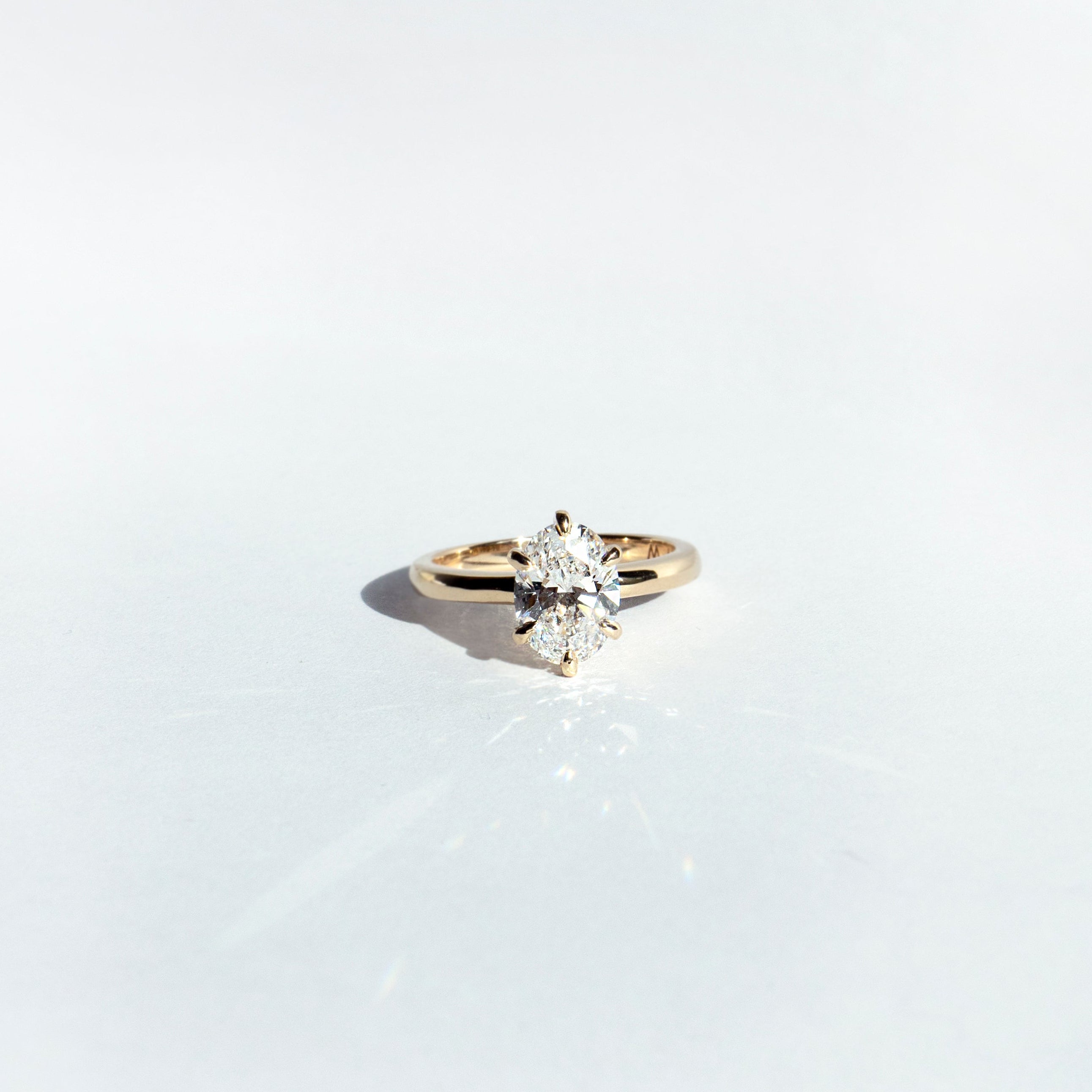 Oval lab-grown diamond solitaire engagement ring with six-pointed prongs in 14k yellow gold