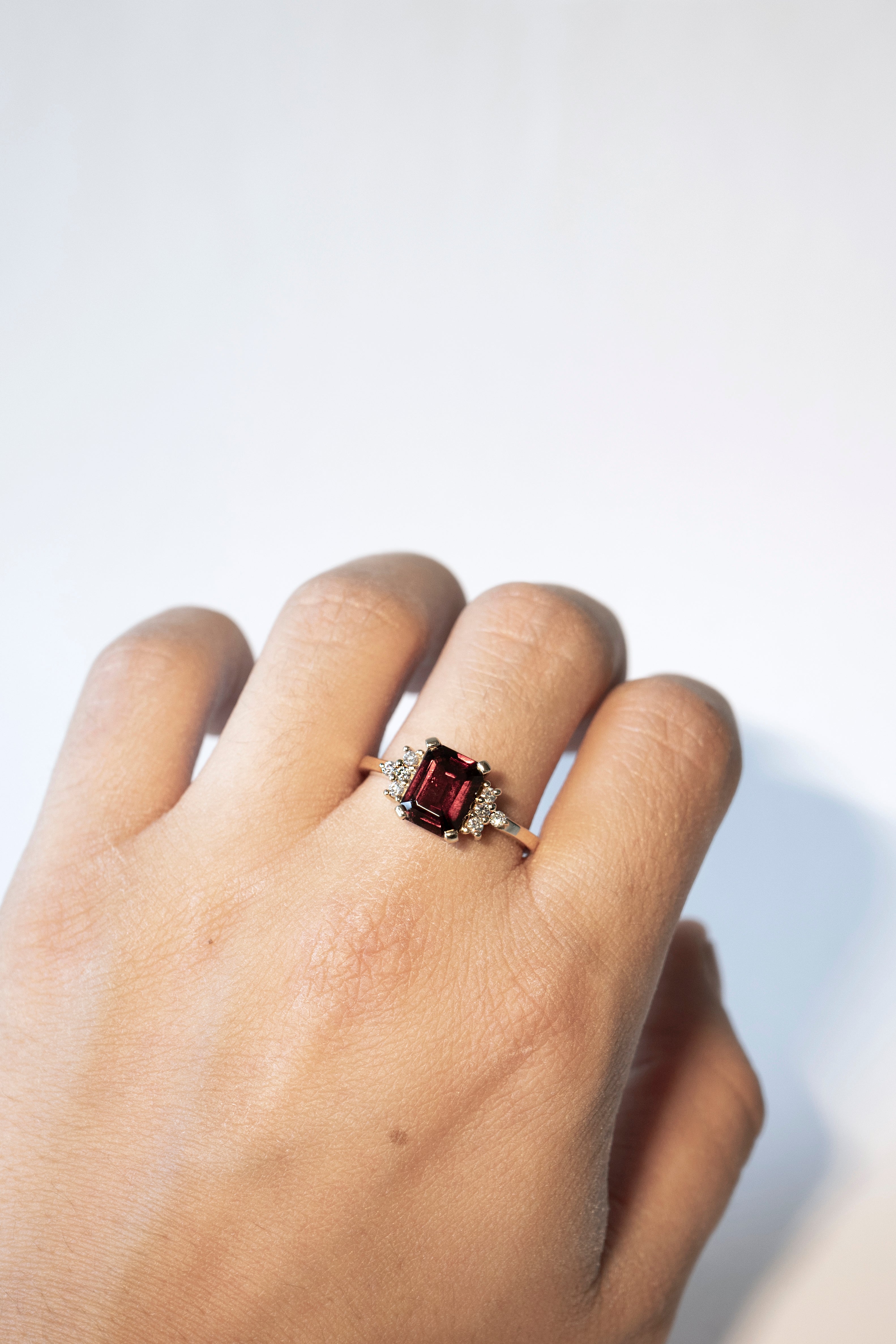 Emerald-cut garnet ring with eight diamonds
