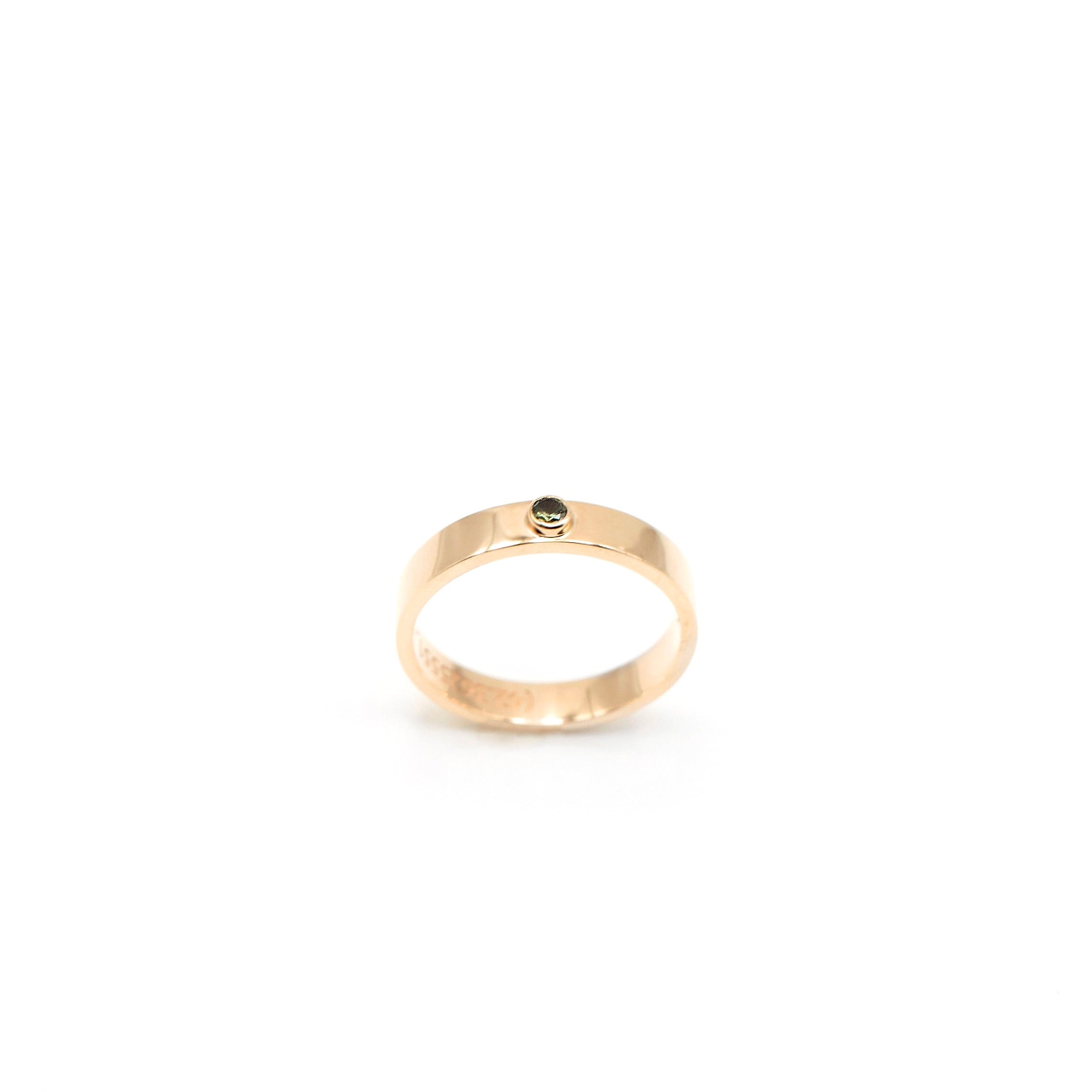 14k gold wedding band with bezel-set green sapphire