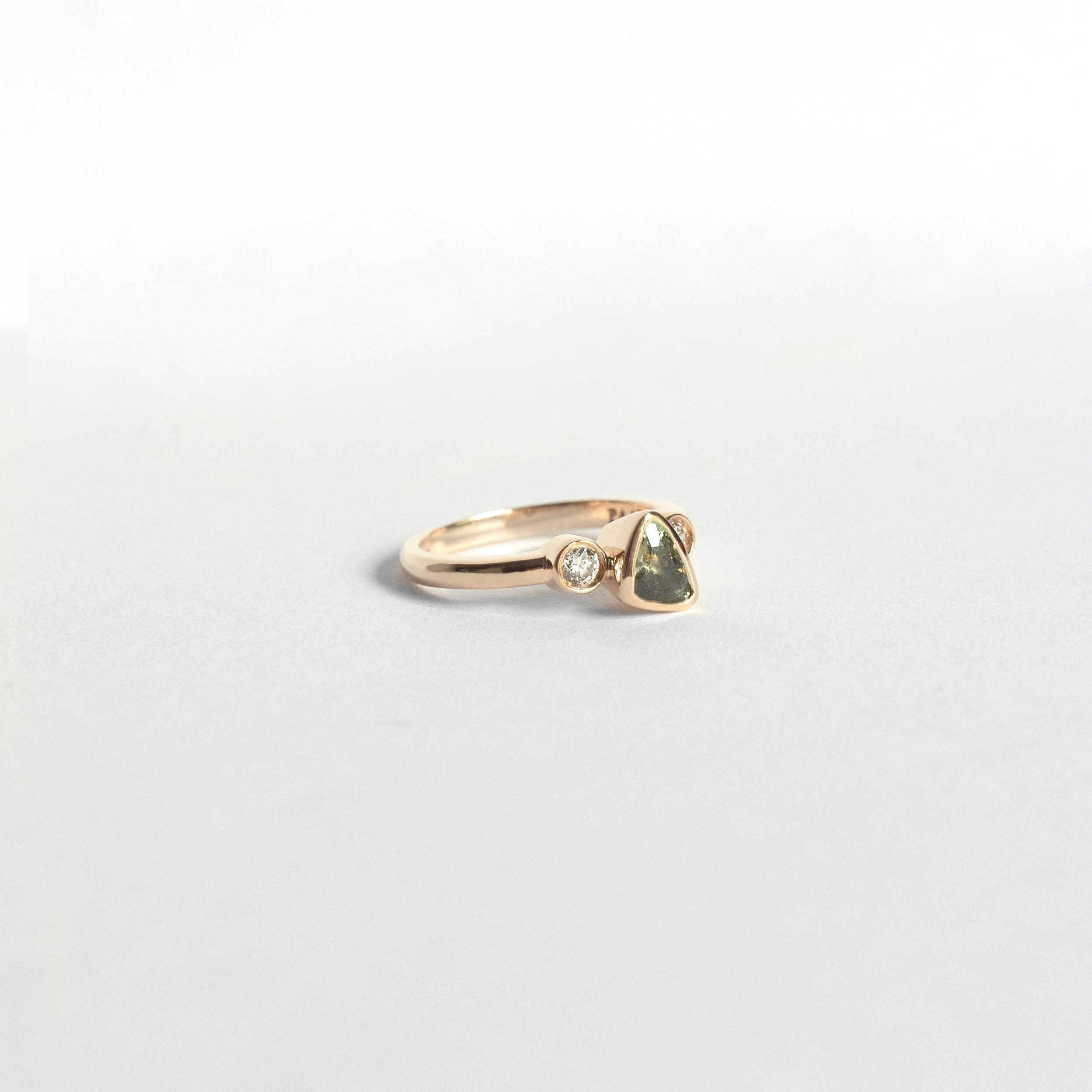 Trillion-cut natural sapphire bezel ring with two white diamonds