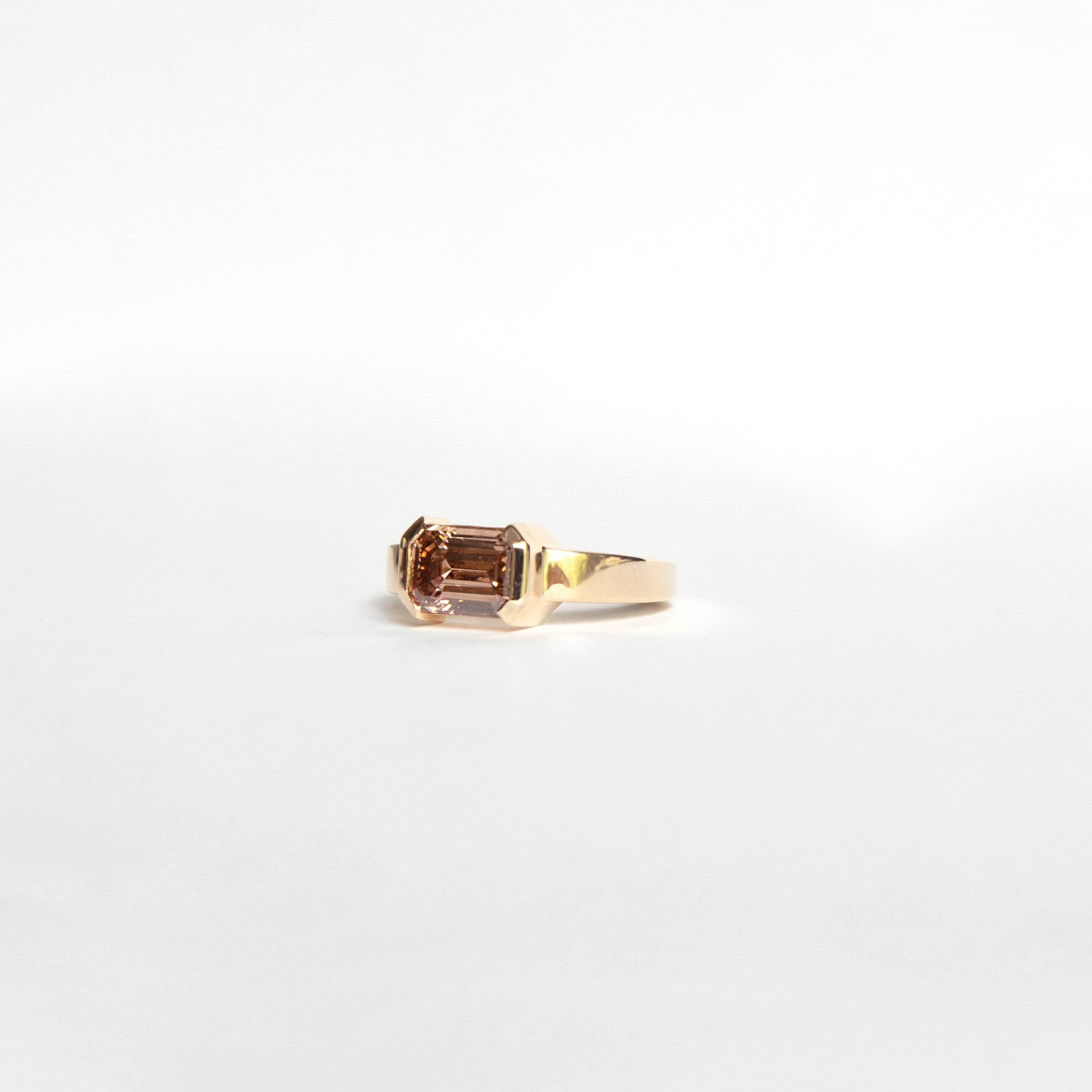 East-west emerald-cut fancy brown lab-grown diamond ring in half bezel