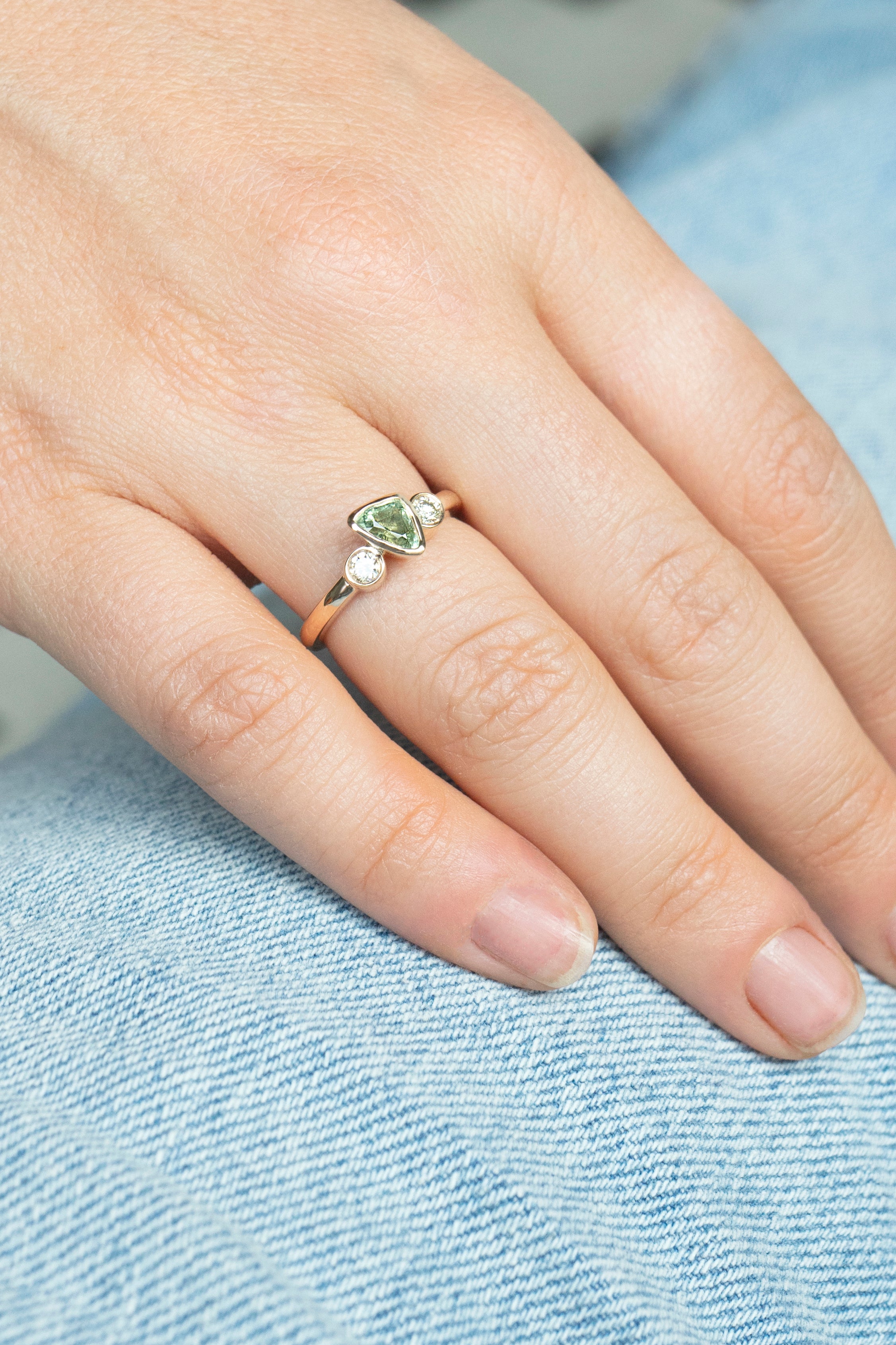 Trillion-cut natural sapphire bezel ring with two white diamonds