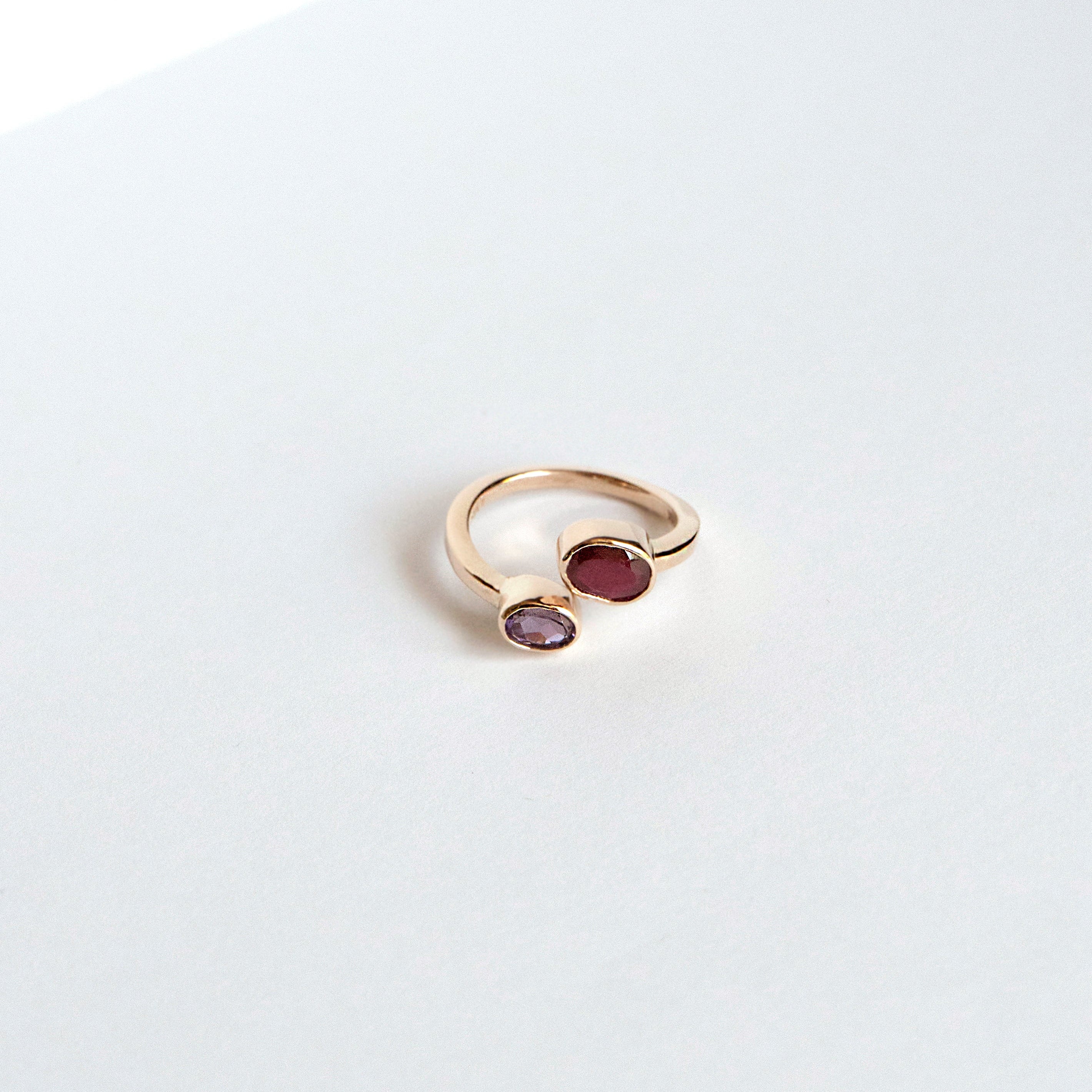 Oval ruby and amethyst bezel ring set east–west