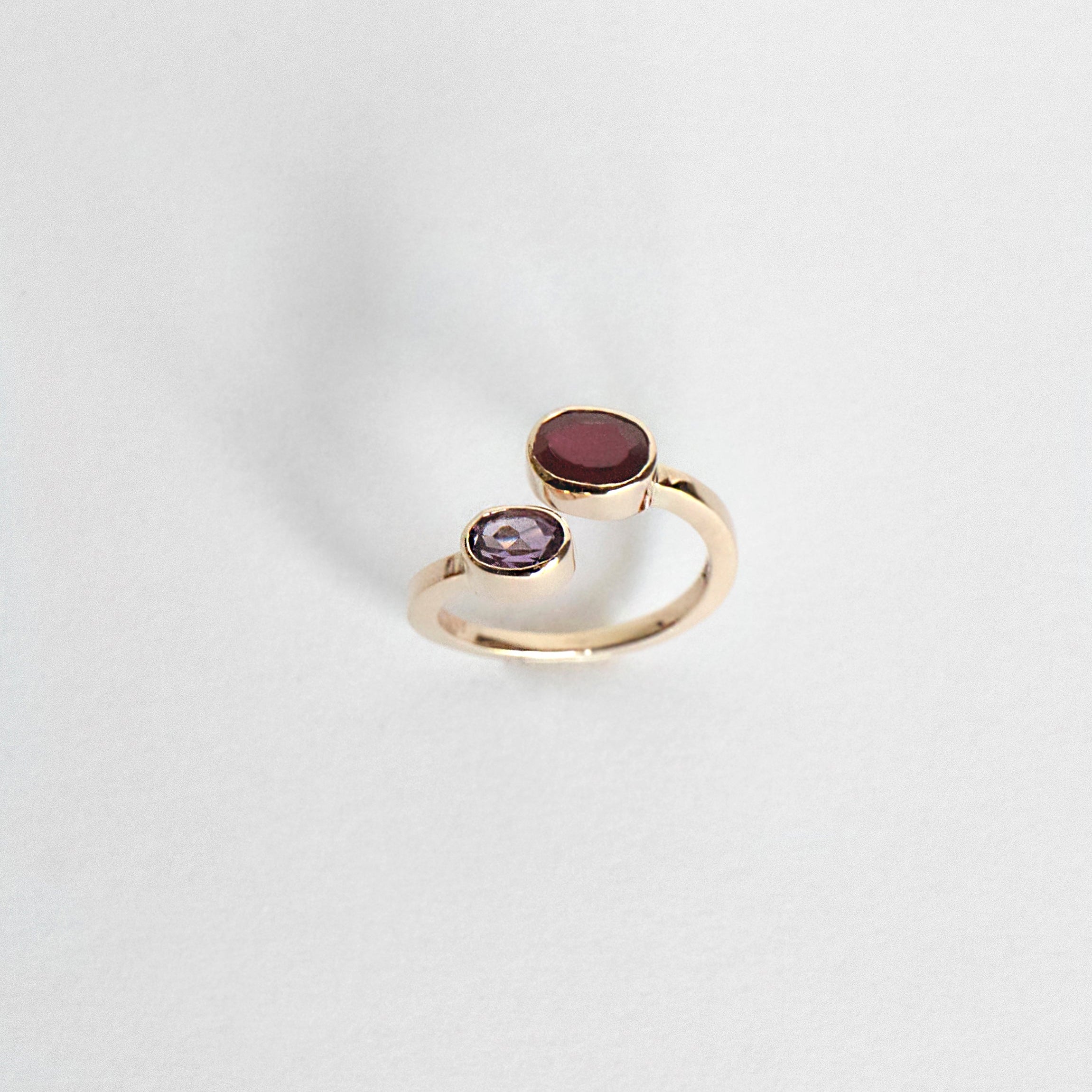 Oval ruby and amethyst bezel ring set east–west