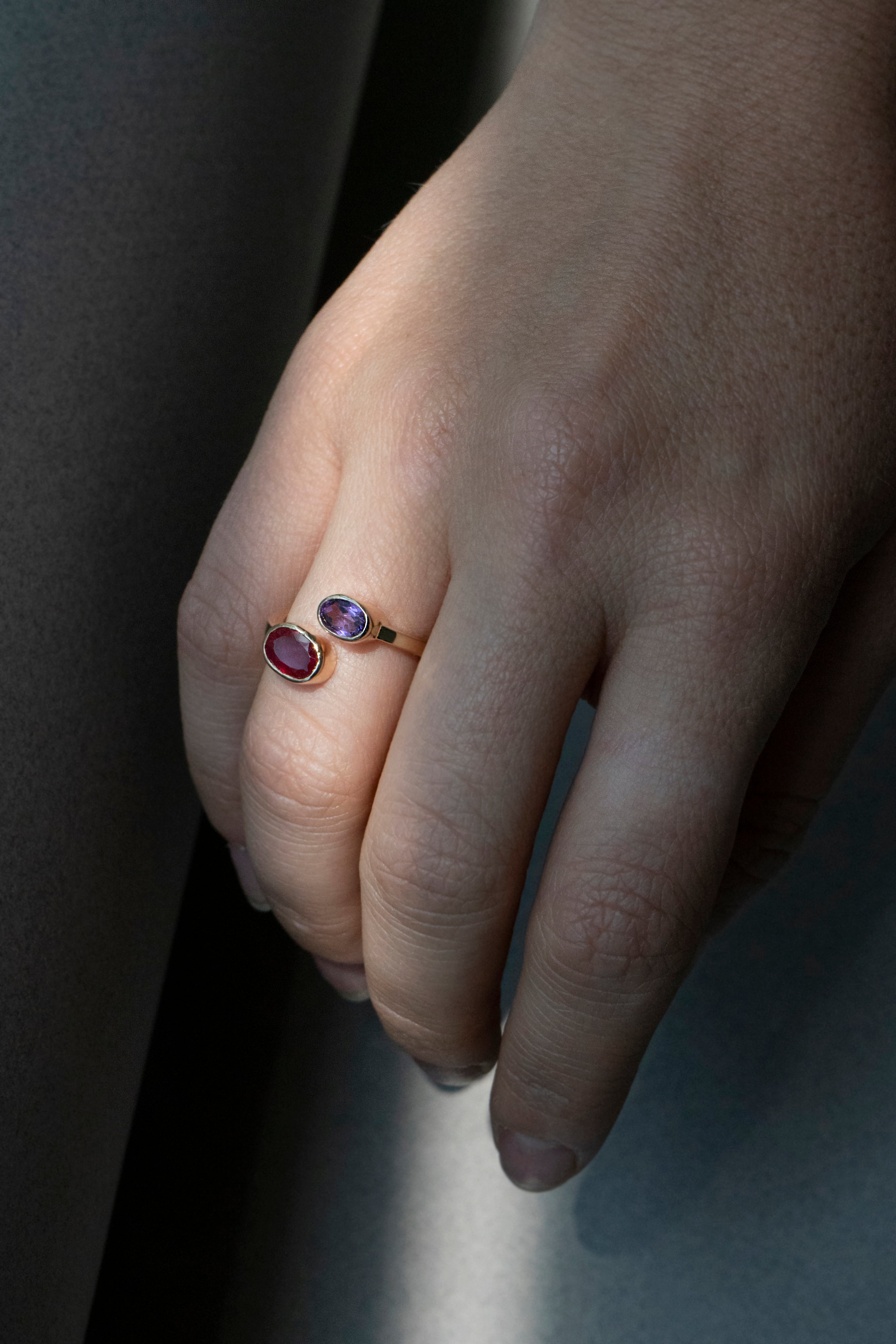 Oval ruby and amethyst bezel ring set east–west