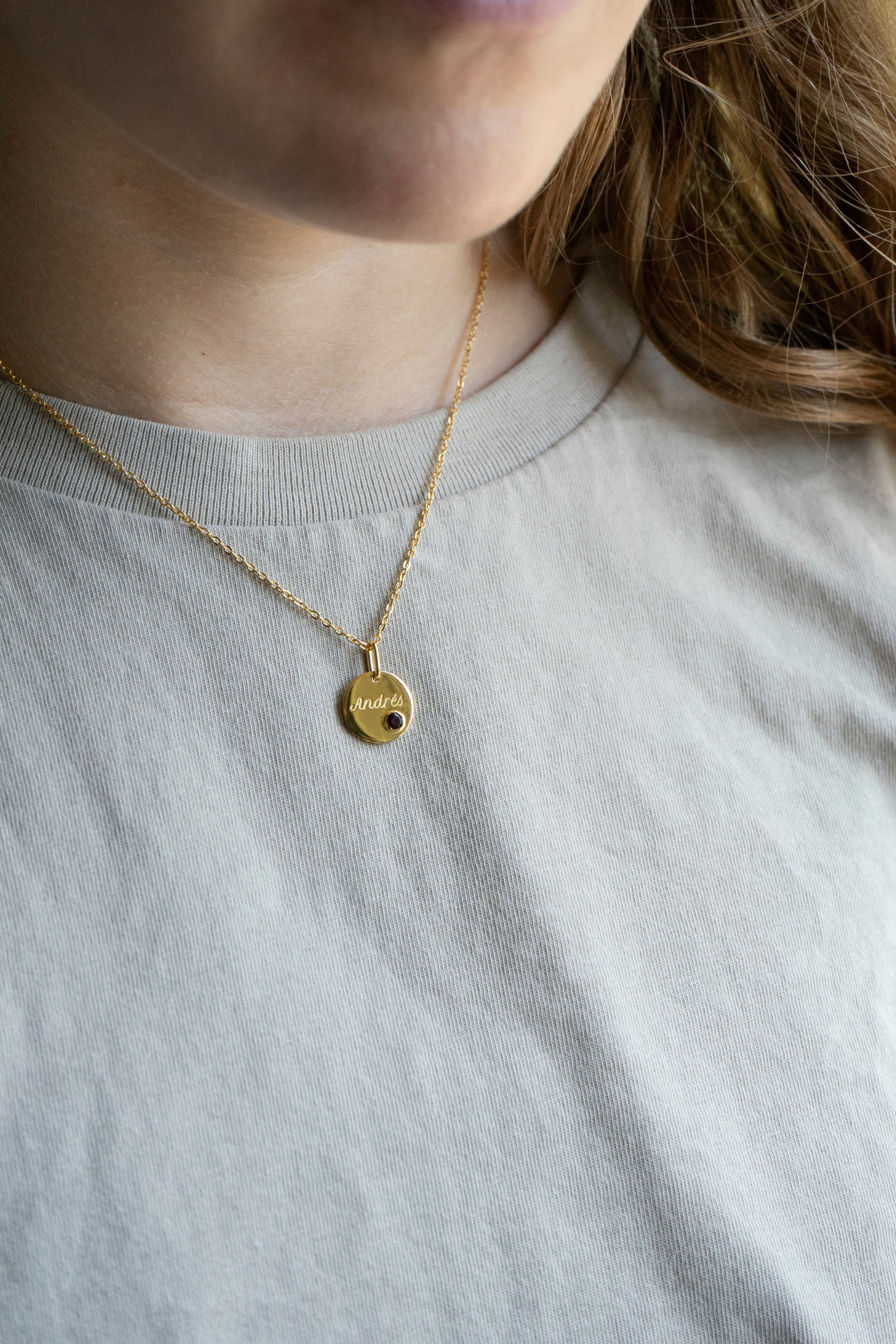 14k gold engraved round pendant necklace with bezel-set garnet