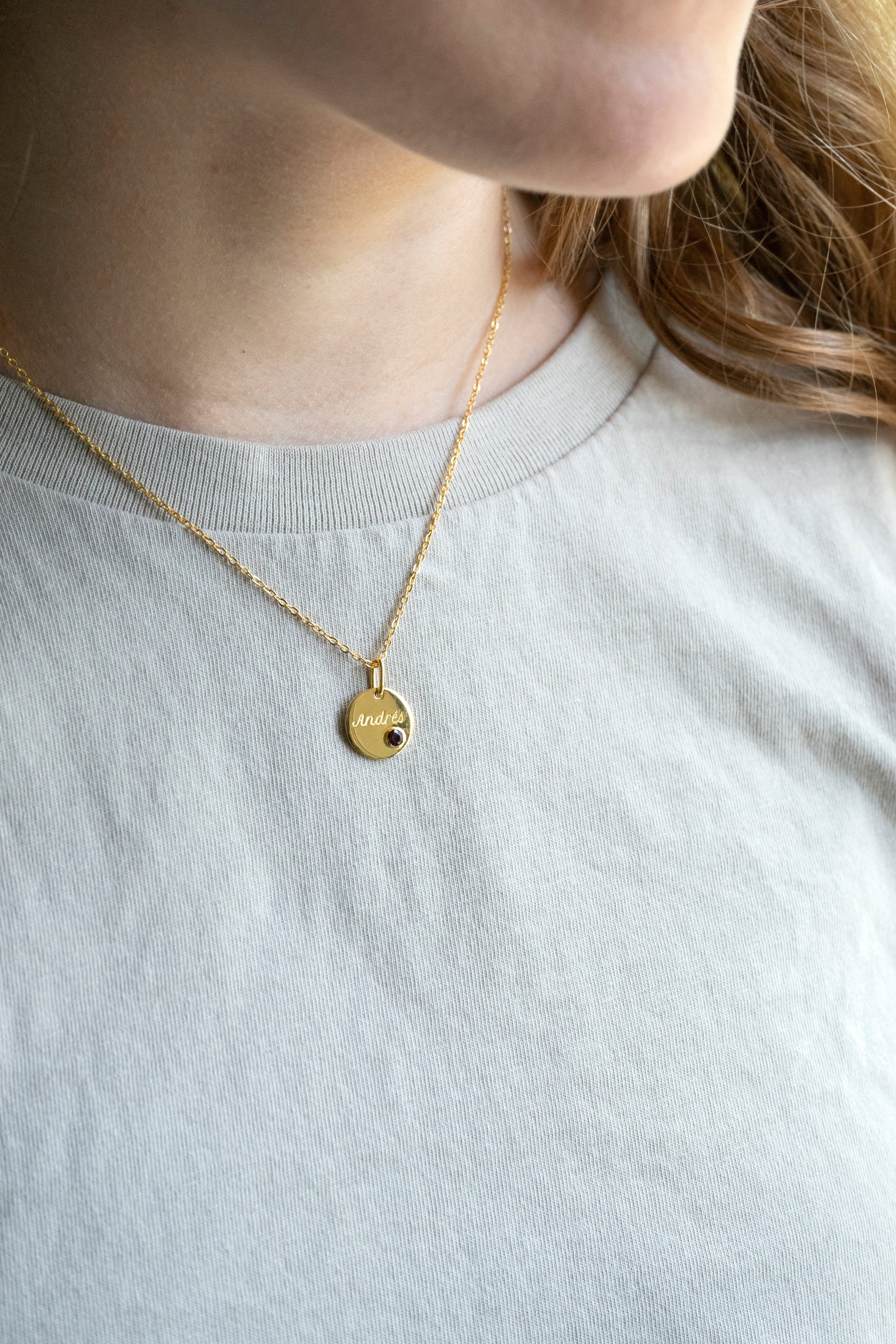 14k gold engraved round pendant necklace with bezel-set garnet