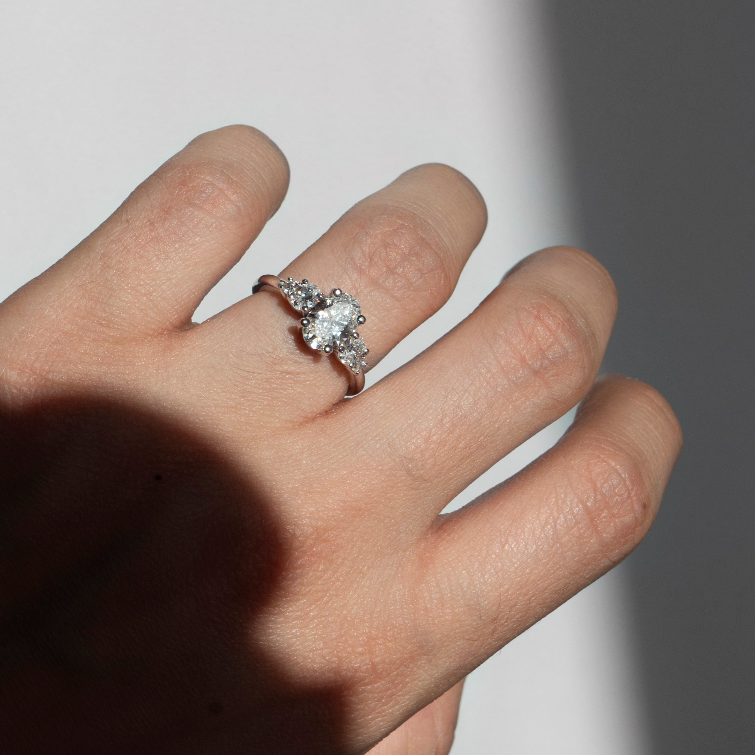 Oval diamond engagement ring with oval and round diamond accents