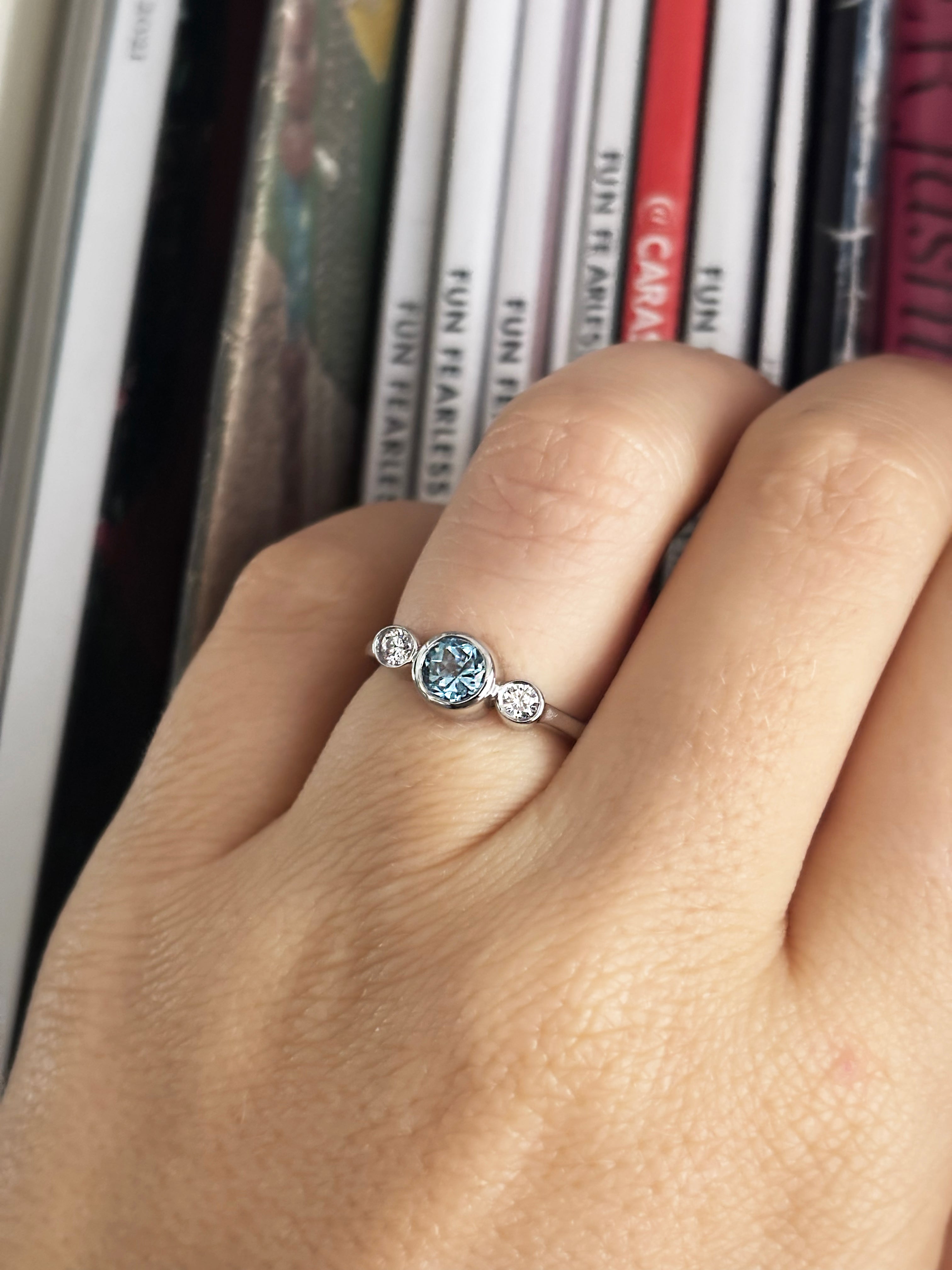 Round blue topaz and diamonds bezel ring