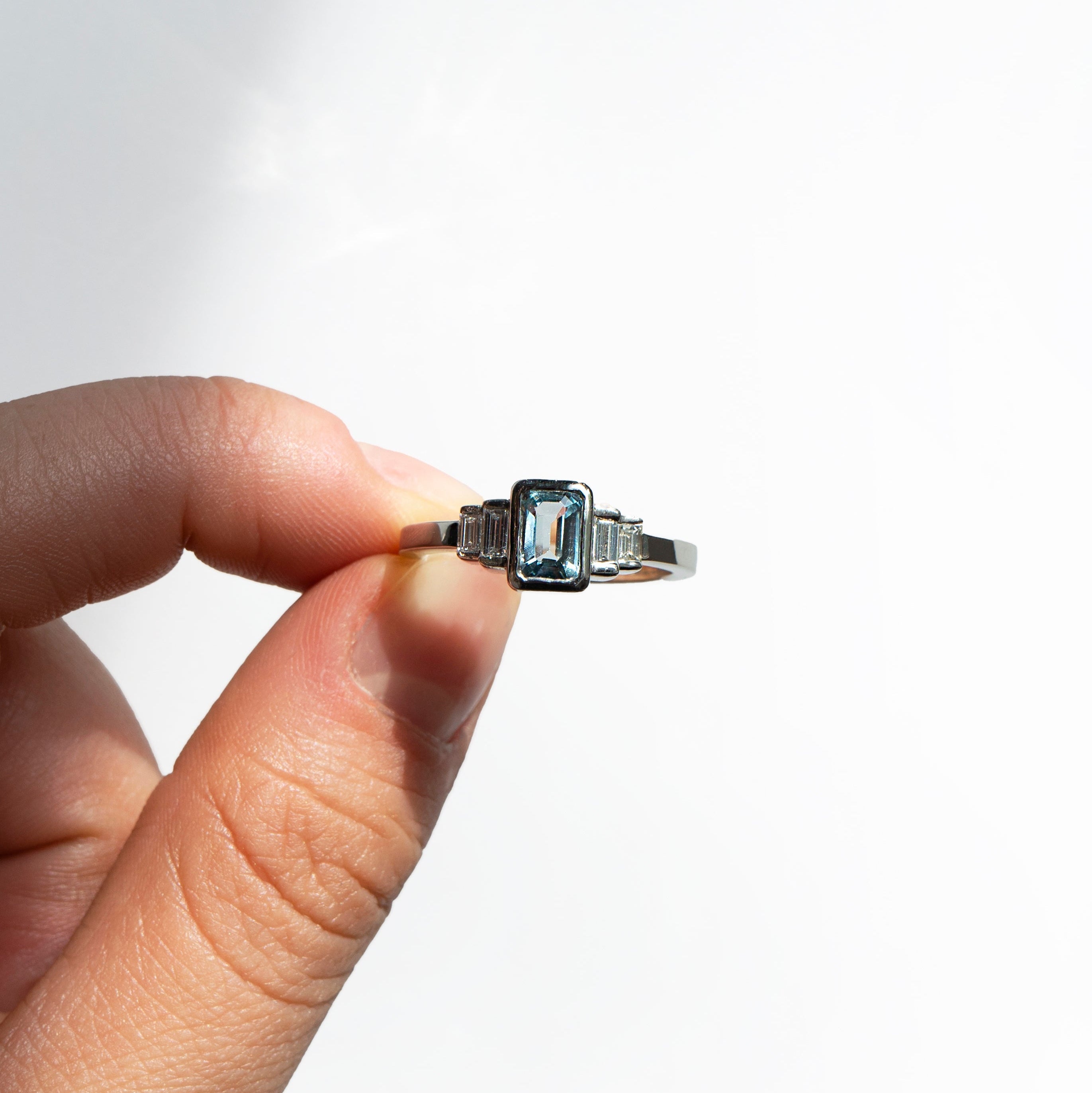 Emerald-cut aquamarine and baguette diamonds platinum engagement ring