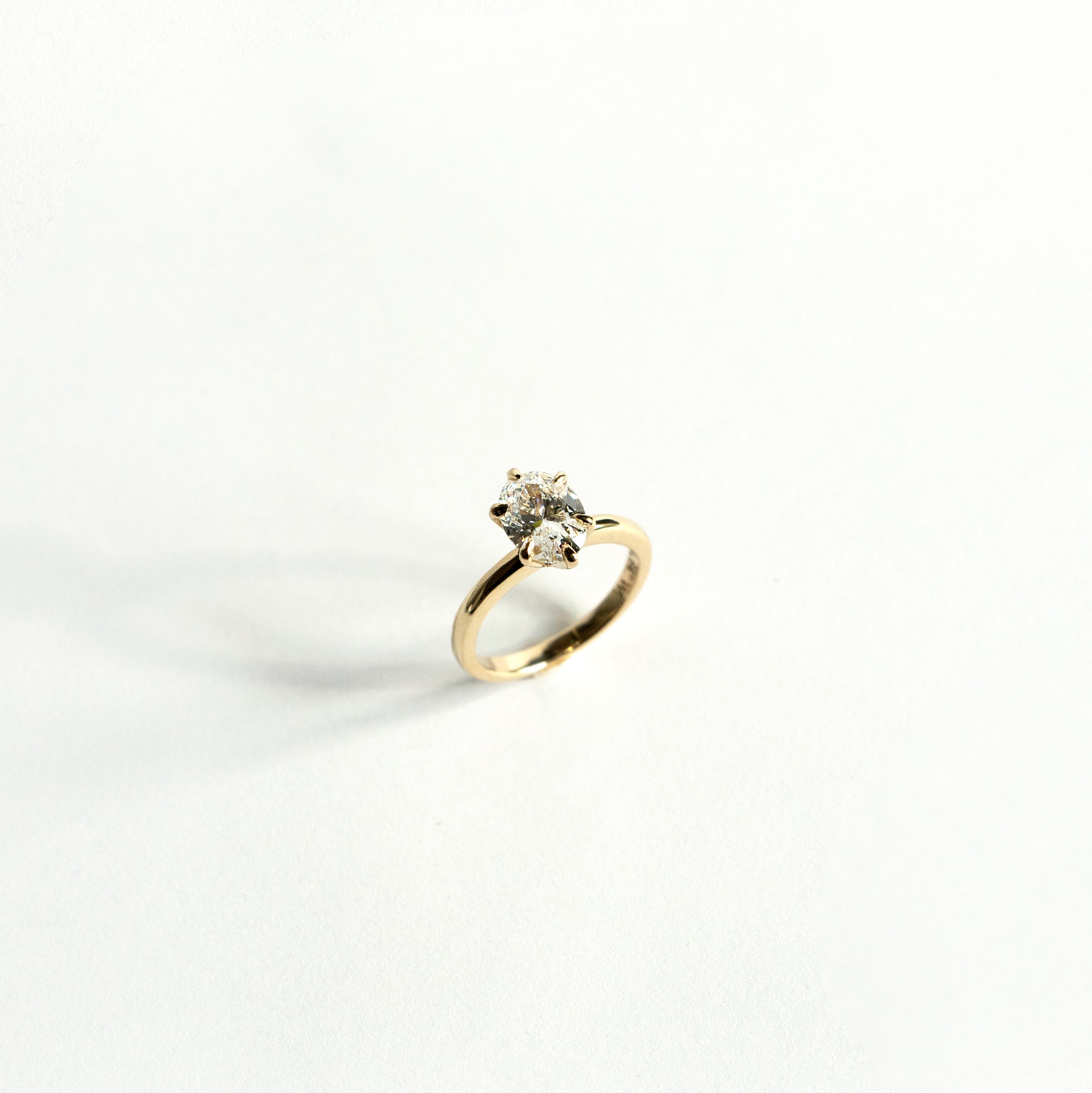 Oval lab-grown diamond solitaire engagement ring with six-pointed prongs in 14k yellow gold