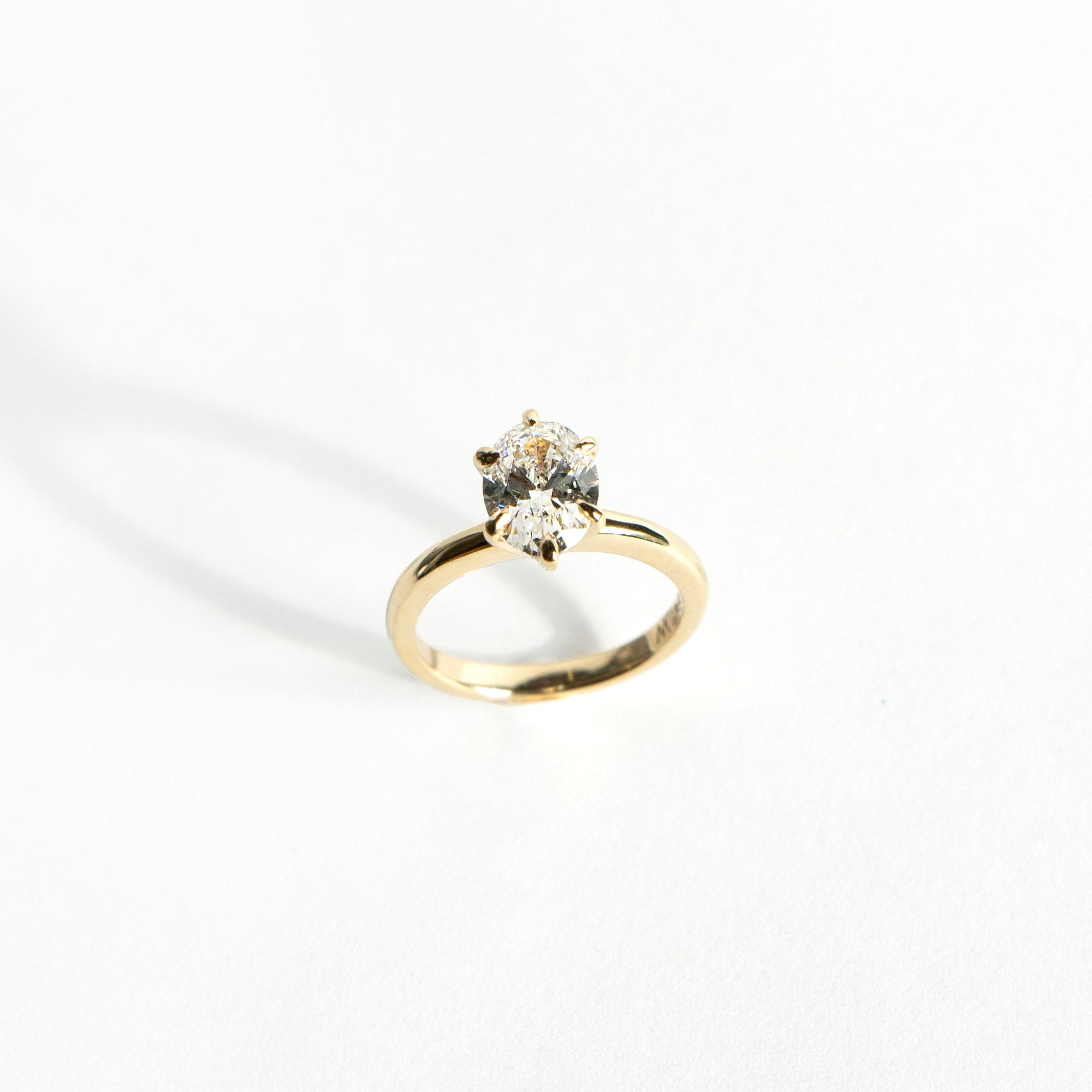 Oval lab-grown diamond solitaire engagement ring with six-pointed prongs in 14k yellow gold