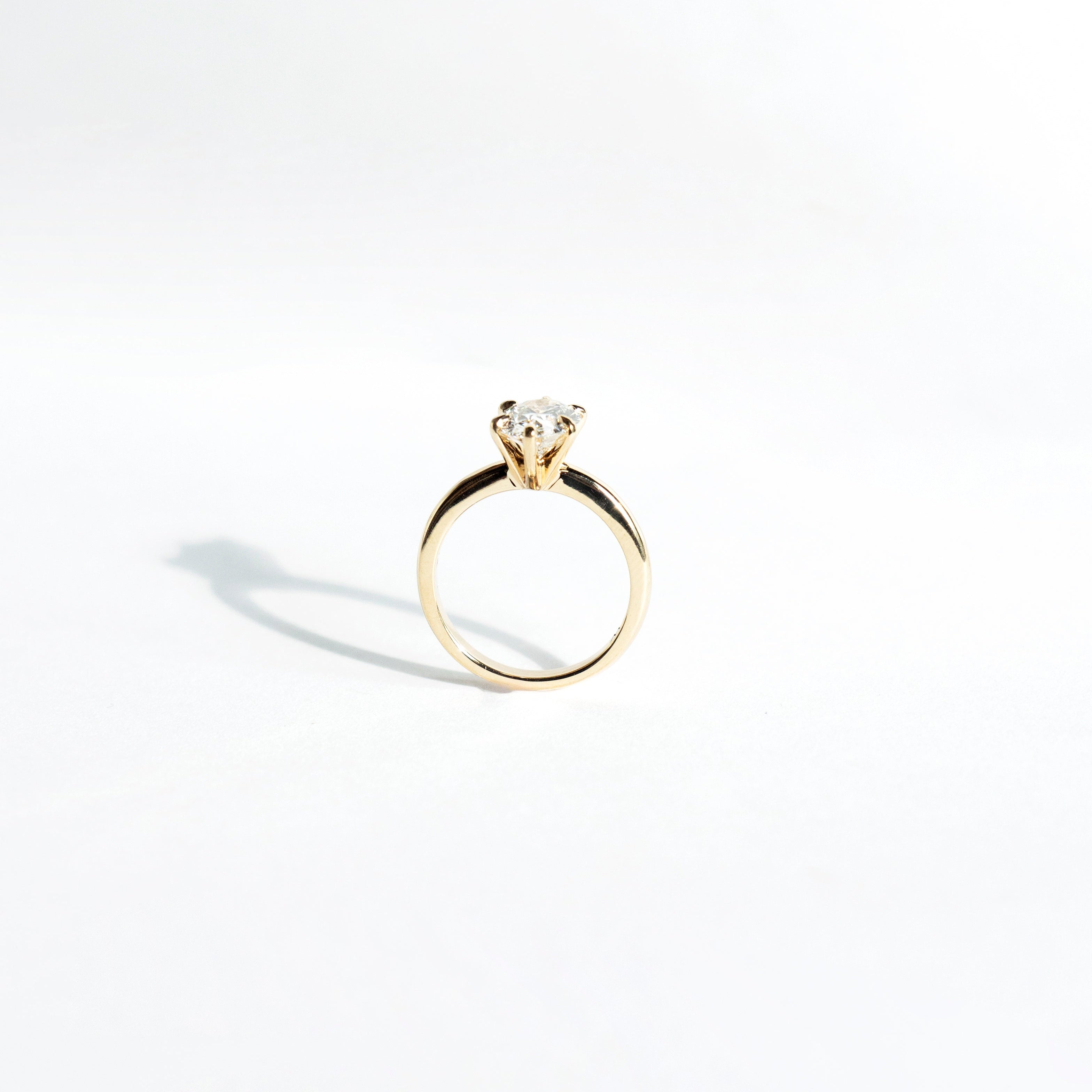Oval lab-grown diamond solitaire engagement ring with six-pointed prongs in 14k yellow gold