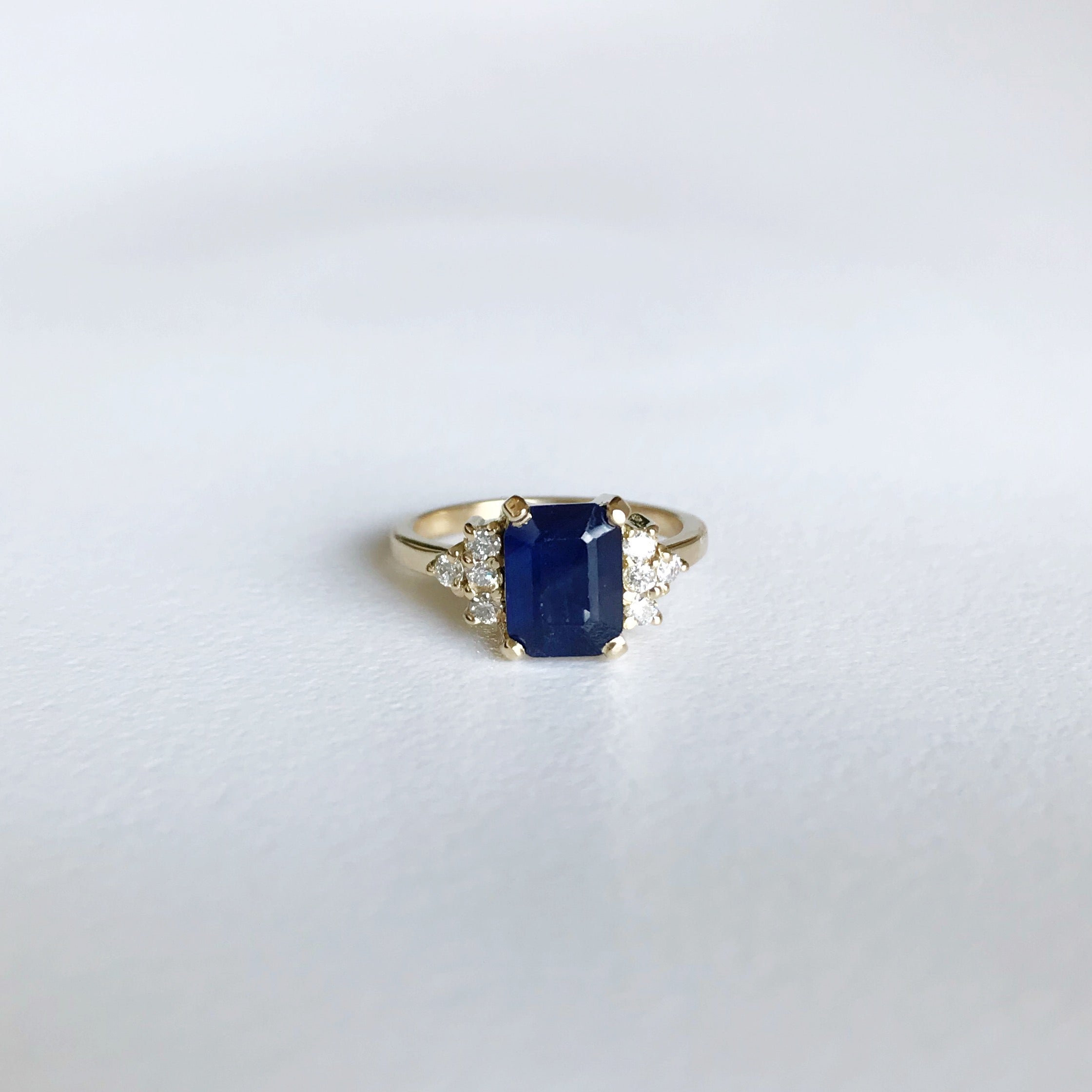 Emerald-cut sapphire and diamond engagement ring